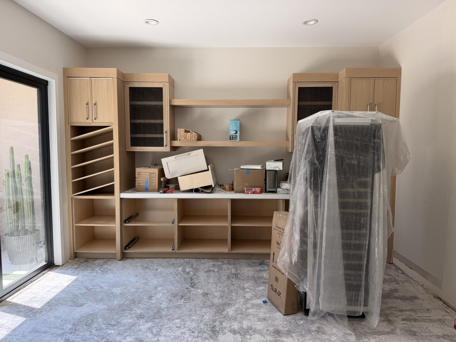 Cabinetry mid-installation with drawer boxes and carcasses in place