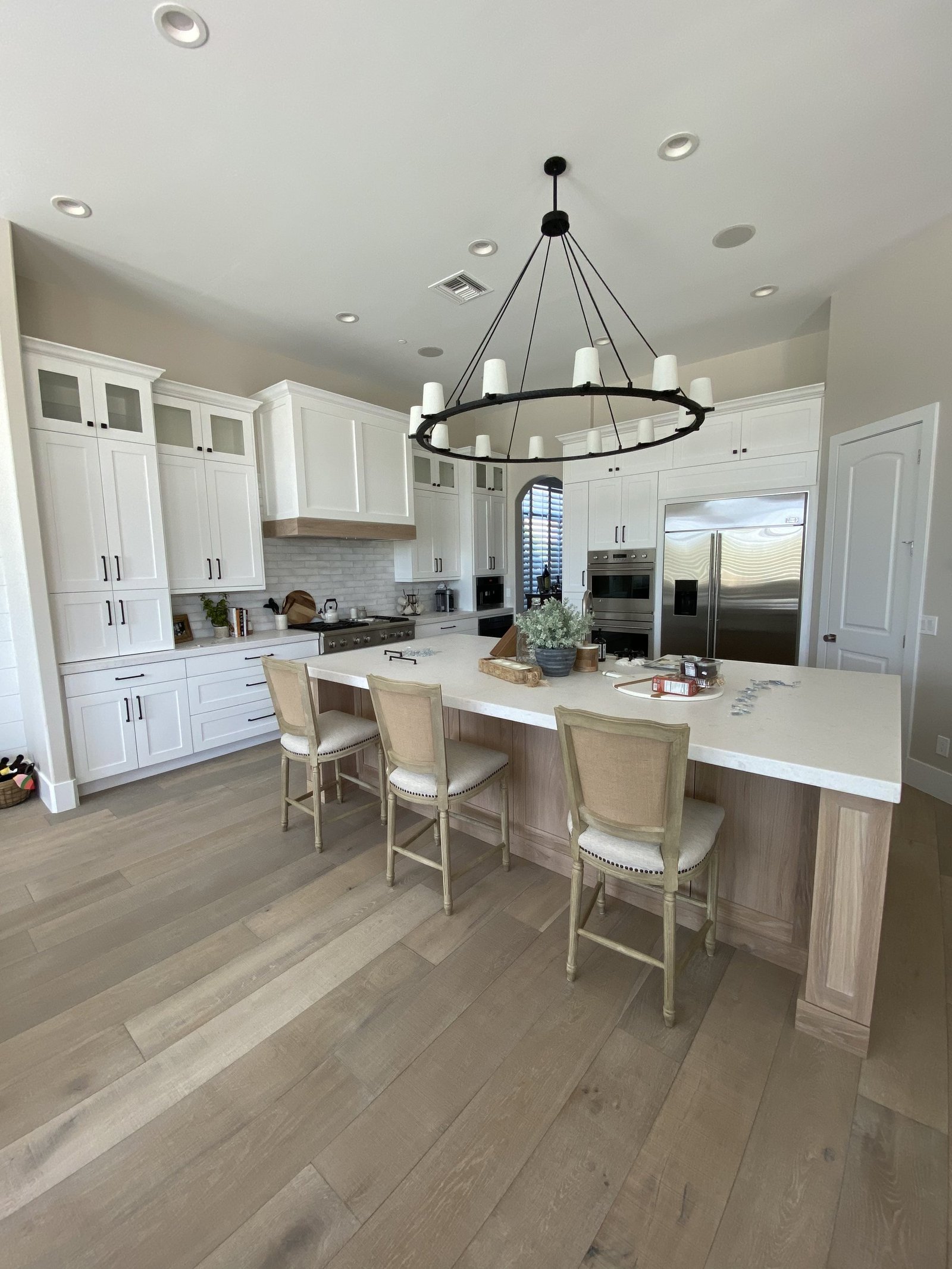 White kitchen with oak island